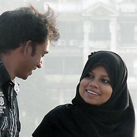 Man and muslim woman talking